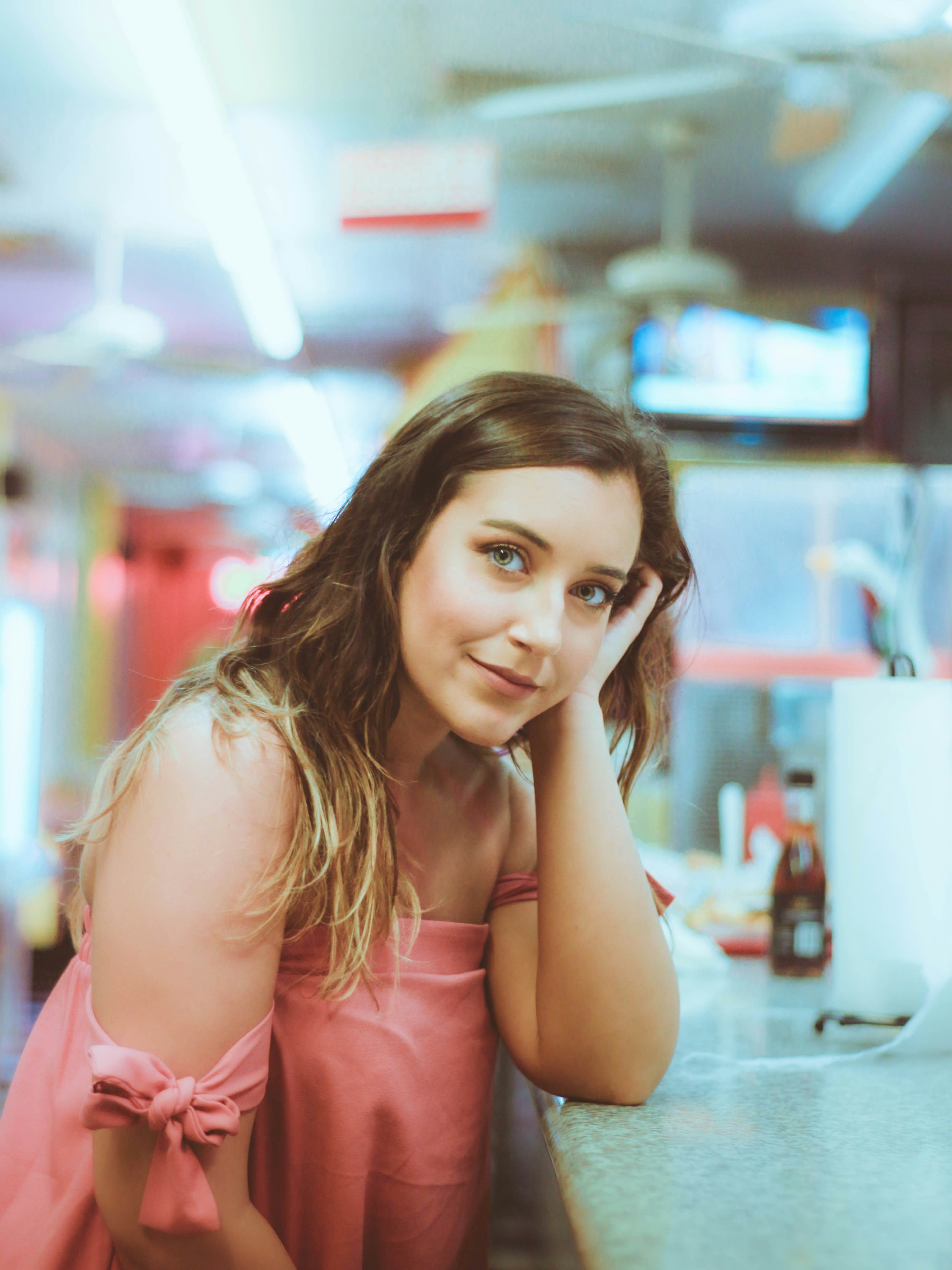 woman wearing pink top taking selfie